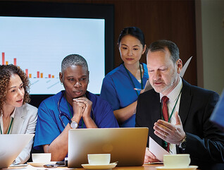 healthcare leaders meet around table