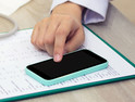 Doctor accesses patient data on smartphone as mobility in healthcare is on the rise