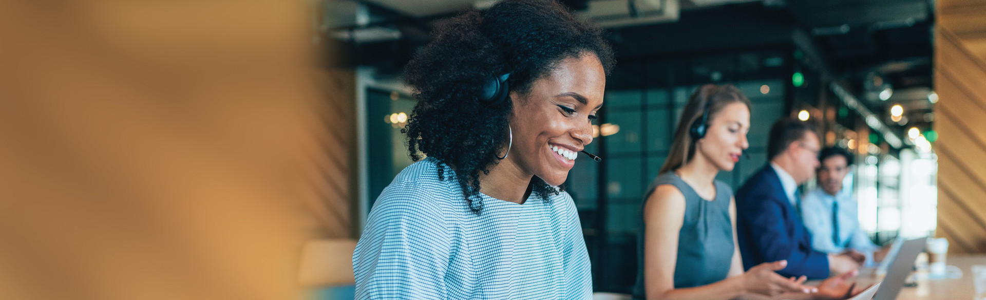 woman on phone at contact center smiling