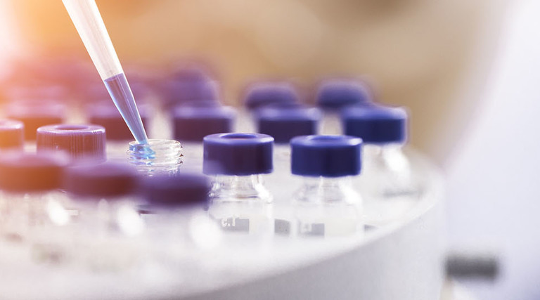 Female chemist at work in laboratory.