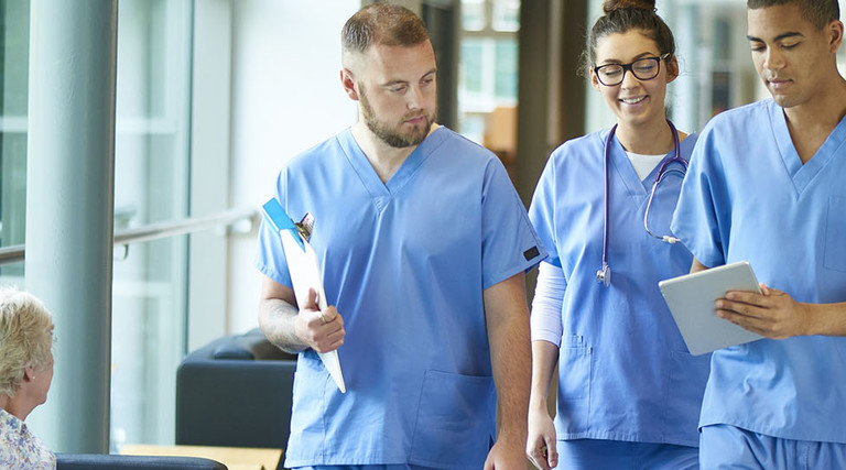 Team of doctors looking at EMR/EHR on tablet