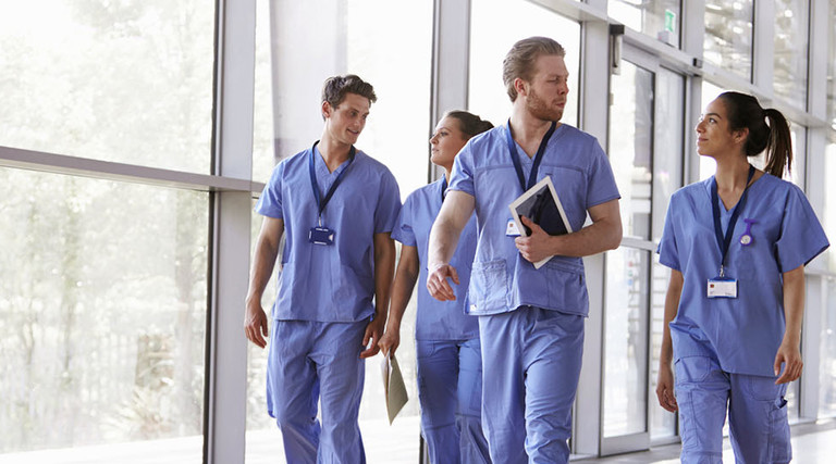 doctors walking through hospital chatting