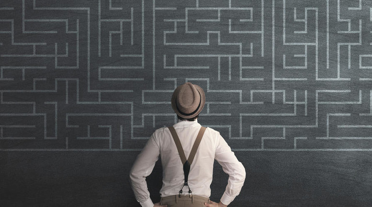 man in fedora looking at chalk maze