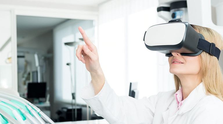 Horizontal color image of female dentist using virtual reality simulator at modern clinic.