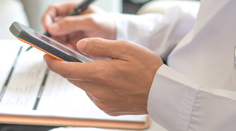 fessional medical doctor using tablet and smartphone for consult patient via online: Physician working tele-consultation 