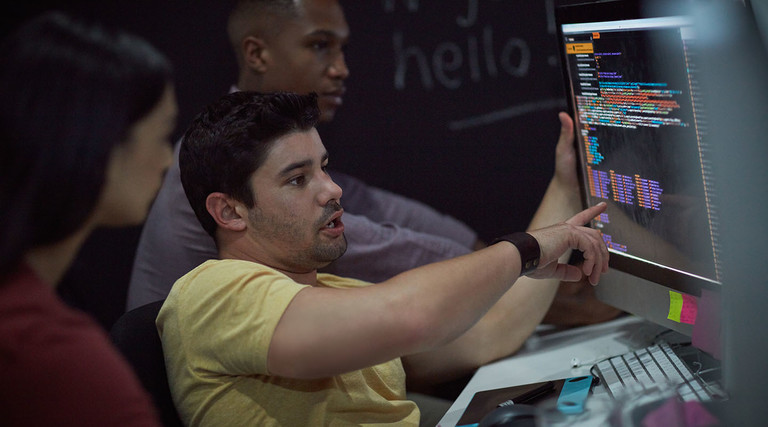 Shot of a group of young businesspeople working on a computer network during a late night at work.