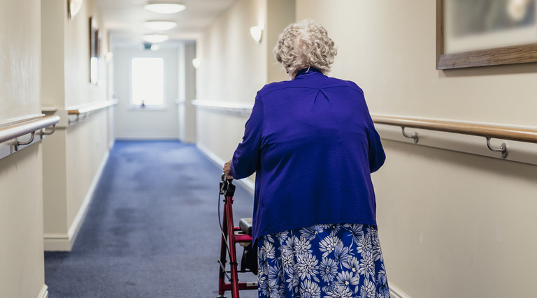 Senior walking in nursing home.