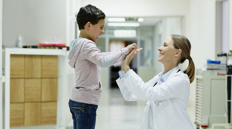 Child high fives doctor