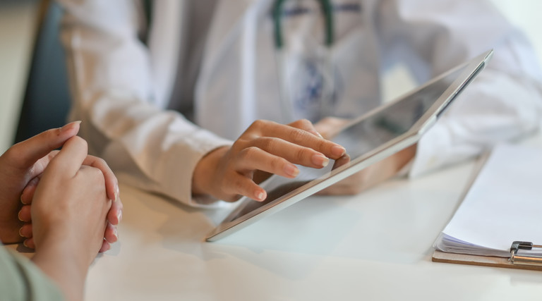 Mobile devices in Healthcare, Doctor uses tablet to show patient data