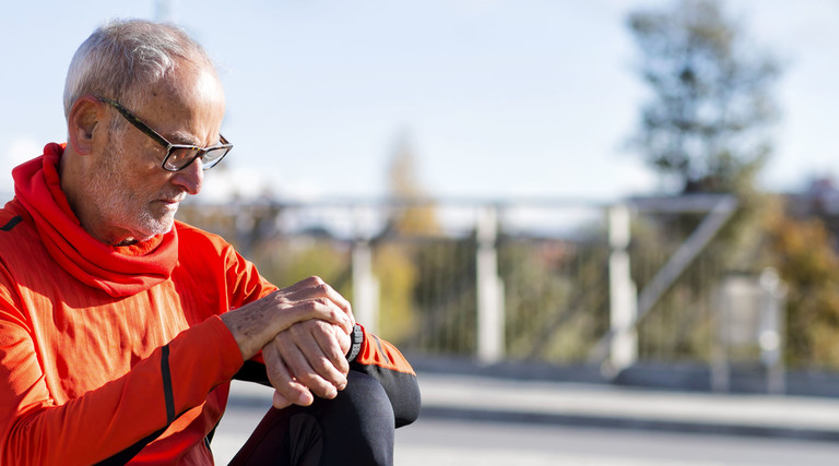 runner looks at smartwatch