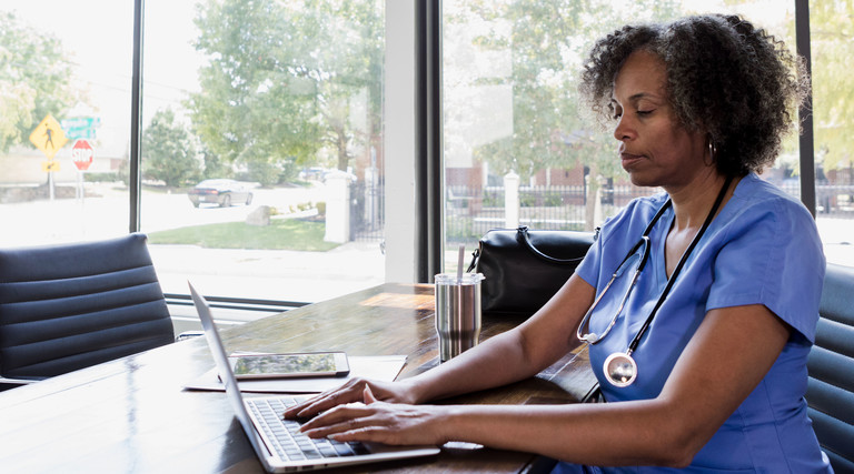 Nurse using laptop for telehealth