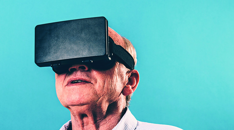 Senior man using VR headset