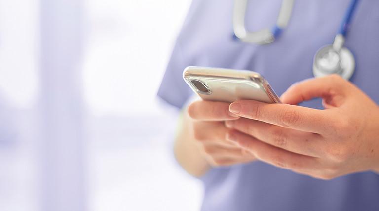 Close shot of nurse on smart phone.