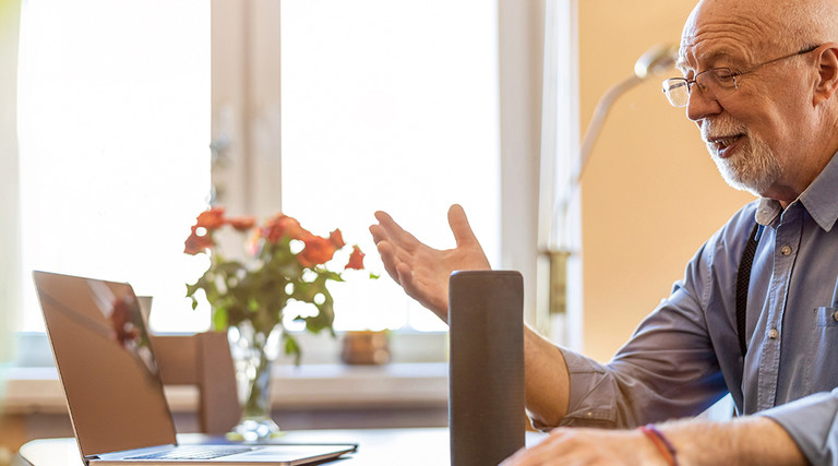 Older adult male using voice assistant technology