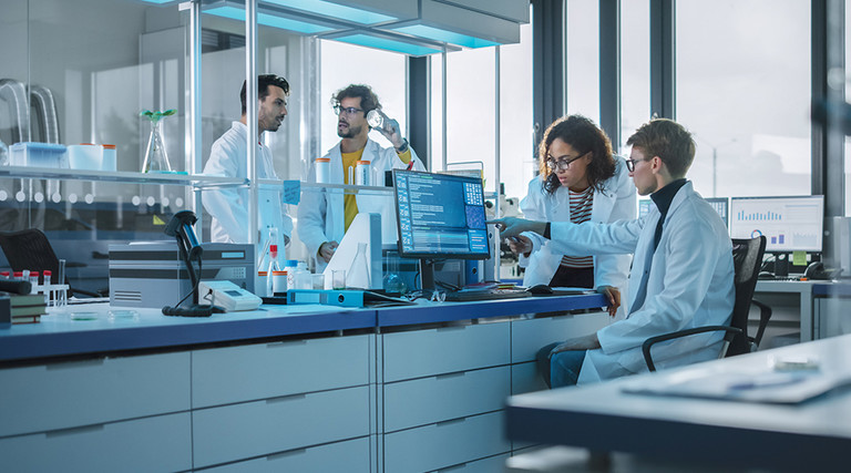 researchers evaluate clinical trial data in lab