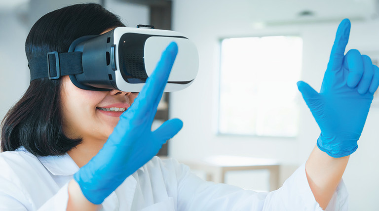 resident in white coat trains using virtual reality glasses