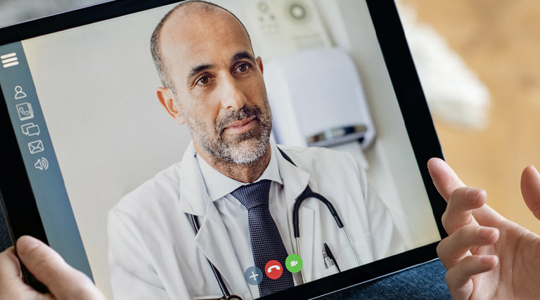 Doctor consulting with patient via telehealth