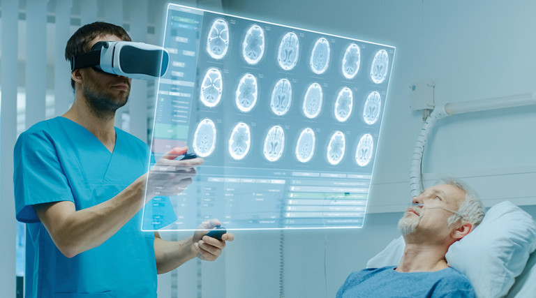 clinician uses spatial computing headset at patient bedside