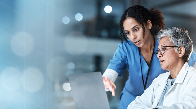 nurse and physician collaborate over laptop