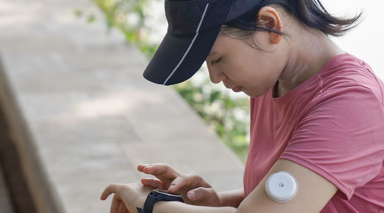 Person wearing glucose monitor 