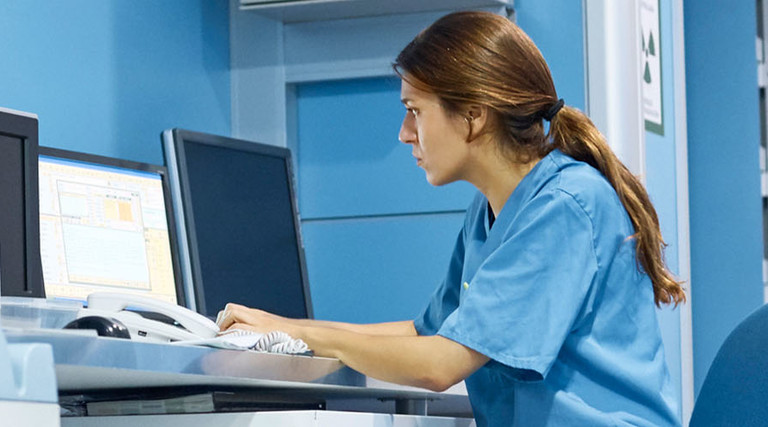 Nurse working on computer in hospital