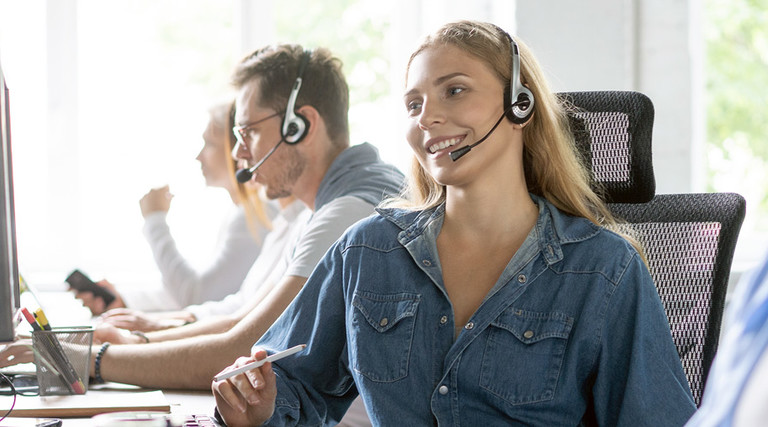 Woman uses headset in call center