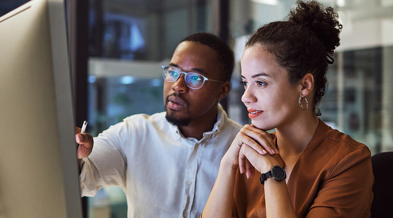 IT team members look at platform on desktop