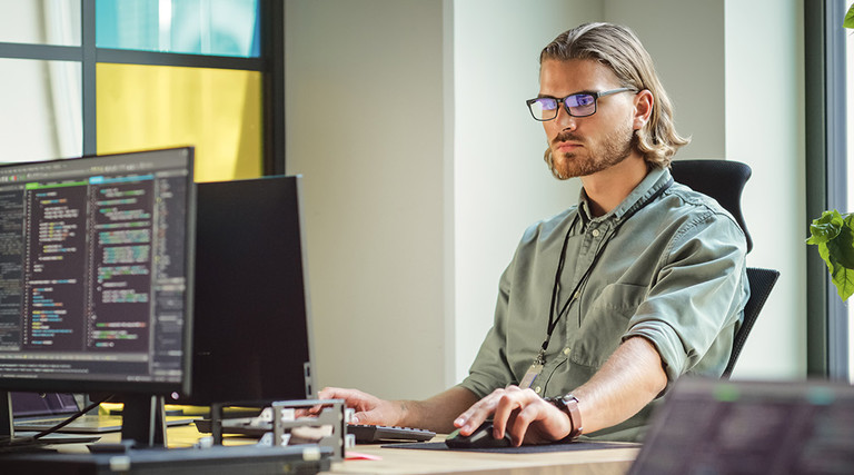 IT person looks at computer screen filled with code