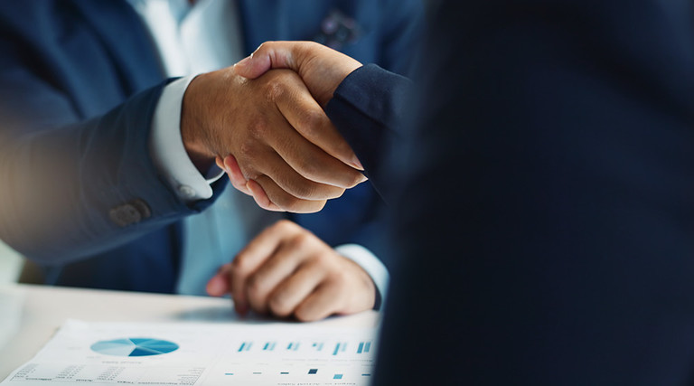two men shake hands