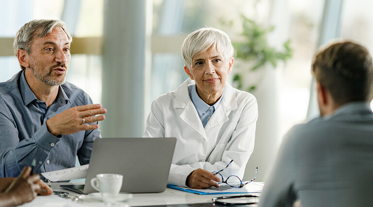 Team of doctors and businessmen having a meeting