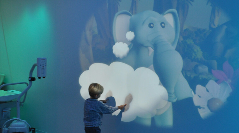 child plays with projection at hospital
