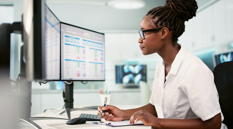 Women at desk working on computer