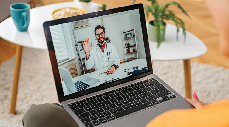 patient on laptap doing a telehealth call with doctor