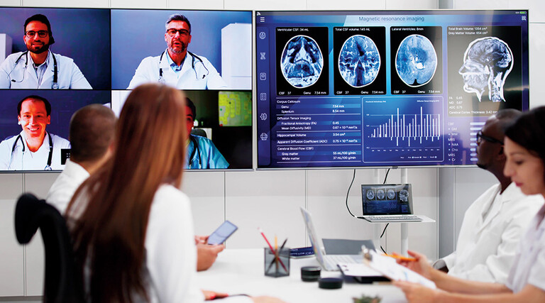 healthcare professionals participate in a hybrid meeting