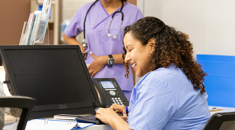 Nurse working at the front desk of a hospital