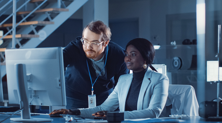IT team confers over monitor