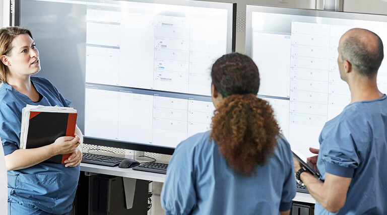 Doctors reviewing information boards