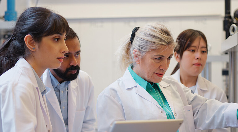 doctors gathered around computer