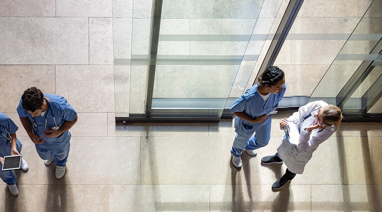 aerial view of doctors and nurses entering a hospital