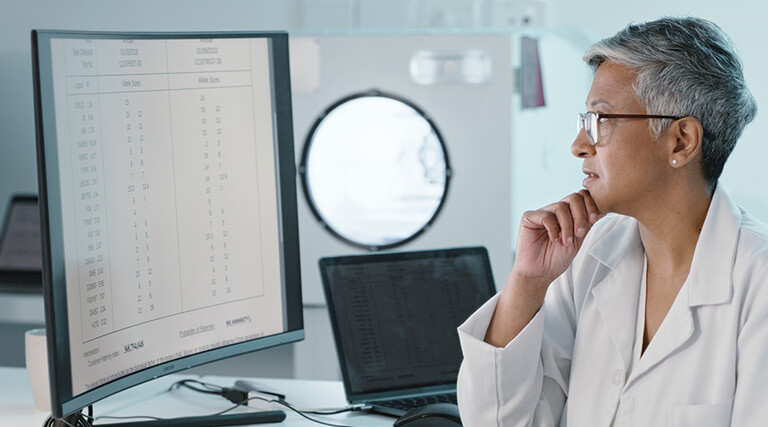 doctor's look at computer monitor together