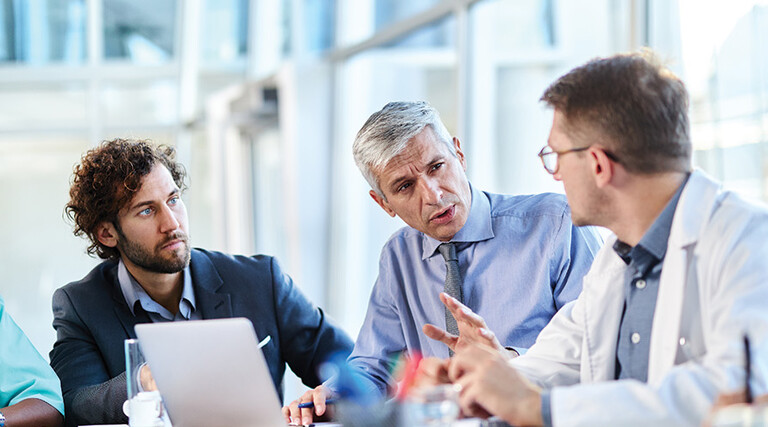 healthcare team have discussion around table