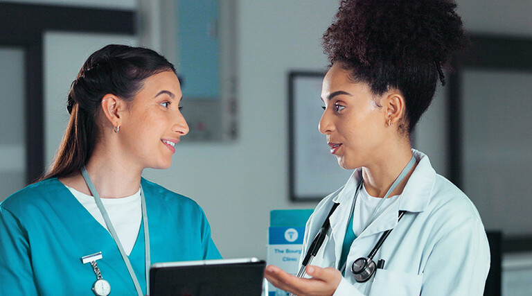 nurse and doctor collaborate over tablet