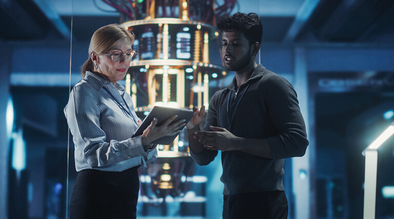 Two people in a tech facility