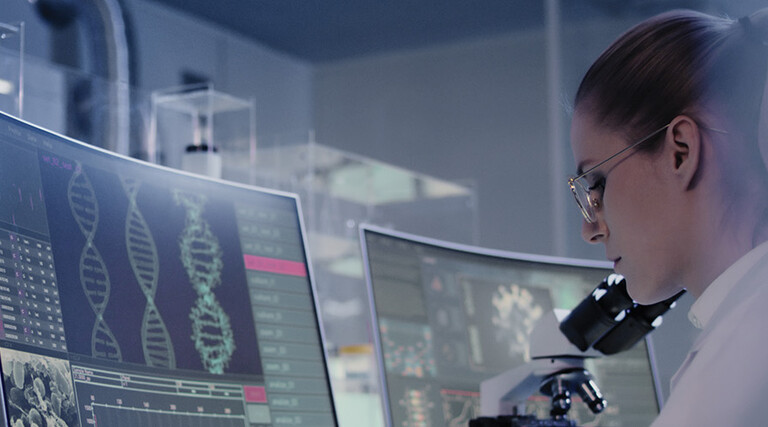 scientist looks at DNA on a computer