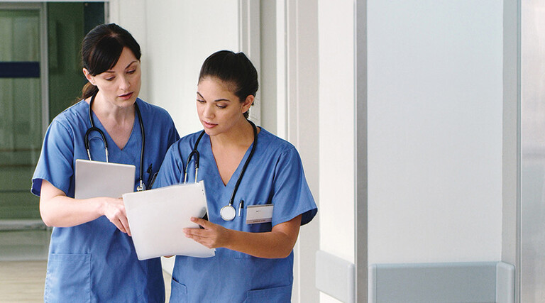 nurses with paper charts