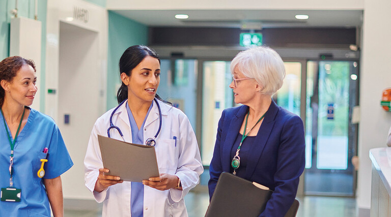 Hospital workers walking down a hallway