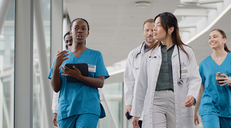 clinicians walking in hospital hallway