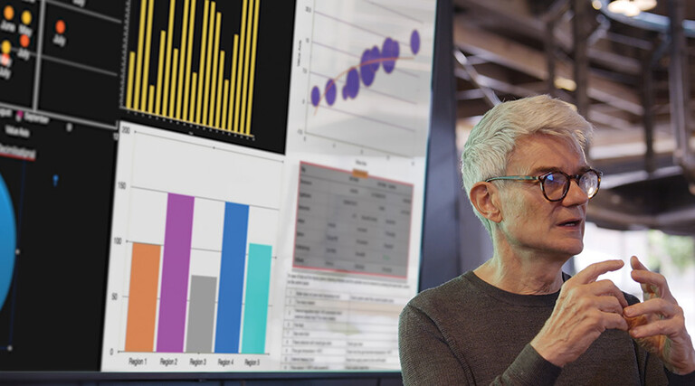 man gives presentation in front of screen with charts