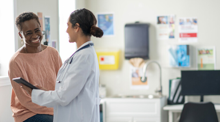 doctor and patient smiling at appointment