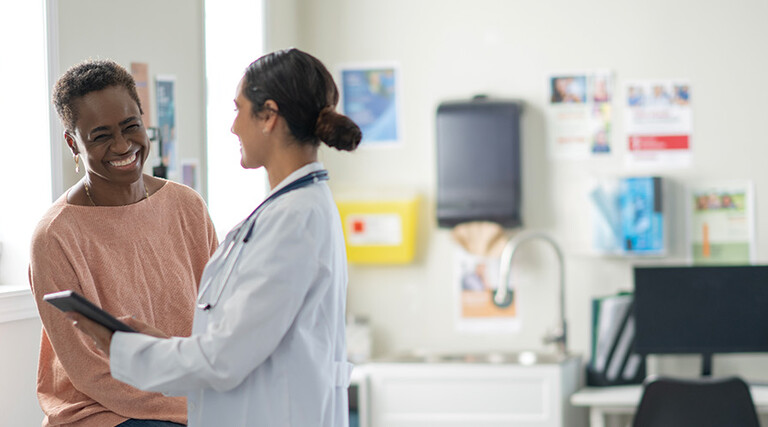 doctor and patient smiling at appointment